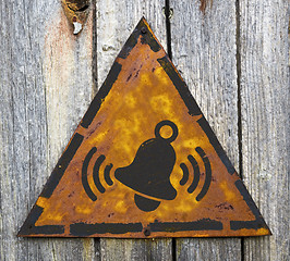 Image showing Ringing Bell Icon on Rusty Warning Sign.