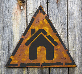 Image showing Home Icon on Rusty Warning Sign.