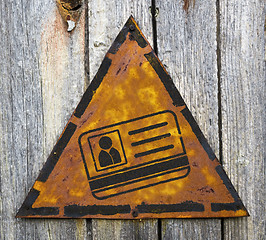 Image showing ID Card Icon on Rusty Warning Sign.