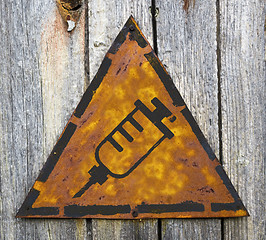 Image showing Syringe Icon on Rusty Warning Sign.
