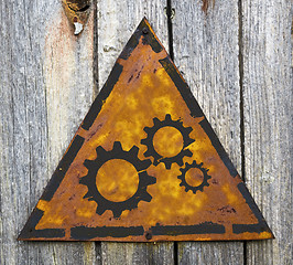 Image showing Cogwheel Gear Icon on Rusty Warning Sign.