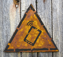 Image showing Smartphone Icon on Rusty Warning Sign.