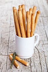 Image showing cup with bread sticks grissini and rosemary