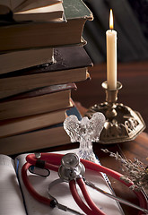 Image showing stethoscope, cup of tea, books, candle. Still life
