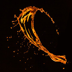 Image showing orange water splash isolated on black