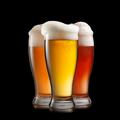 Image showing Different beer in glasses isolated on black background