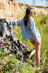 Image showing Young beautiful woman on stump