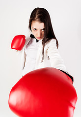 Image showing young businesswoman in boxing gloves