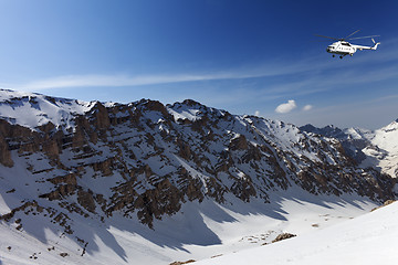 Image showing Helicopter in snowy sunny mountains