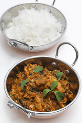 Image showing Methi chicken and rice in kadai bowls vertical
