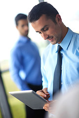 Image showing business man using tablet compuer at office