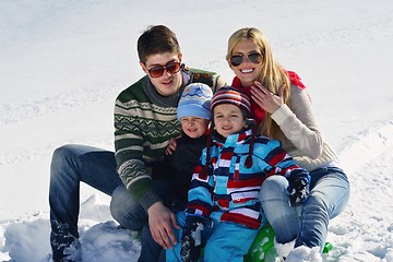 Image showing family having fun on fresh snow at winter vacation