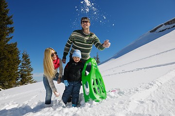 Image showing family having fun on fresh snow at winter vacation