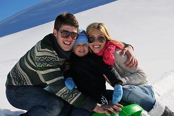 Image showing family having fun on fresh snow at winter vacation