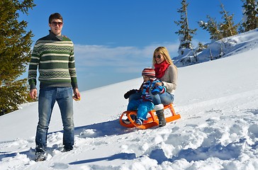 Image showing family having fun on fresh snow at winter vacation