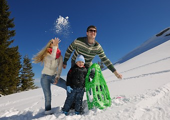 Image showing family having fun on fresh snow at winter vacation