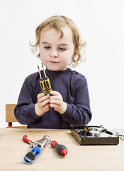 Image showing child choosing tool for repairing hard drive