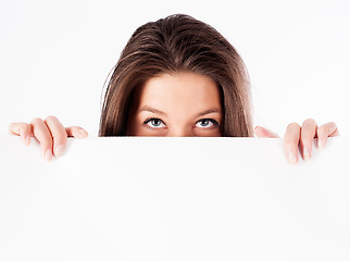 Image showing woman hiding behind billboard