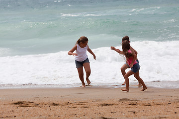 Image showing Three children running at the beach