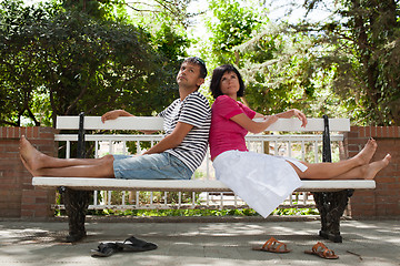 Image showing Happy couple sitting on bench in the park