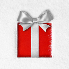 Image showing gift with a bow on snow background