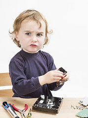 Image showing child repairing computer part