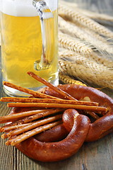 Image showing Salted pretzel sticks and a beer.
