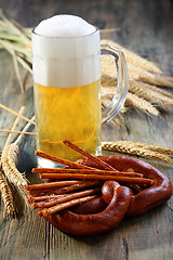 Image showing Pretzel, salty sticks and a glass of beer.