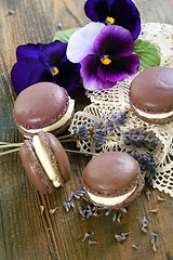 Image showing Macarons and flowers violets. 