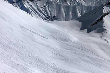 Image showing View on snowy off piste slope with trace from ski, snowboards an