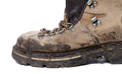 Image showing Old trekking boot in mud