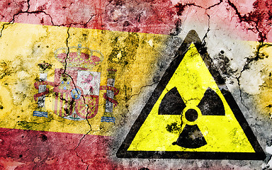 Image showing Old cracked wall with radiation warning sign and painted flag