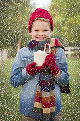 Image showing Young Boy in Warm Clothing Holding Hot Cocoa Mug Outside