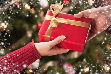 Image showing Man and Woman Gift Exchange with Snow Flakes Border