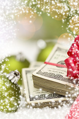 Image showing Stack of Hundred Dollar Bills with Bow Near Christmas Ornaments