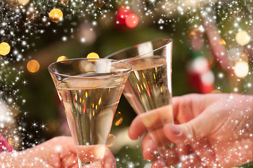 Image showing Man and Woman Toasting Champagne in Front of Lights