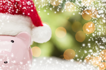 Image showing Pink Piggy Bank with Santa Hat on Snowflakes