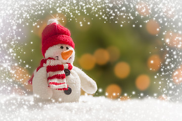 Image showing Cute Snowman Over Abstract Snow and Light Background