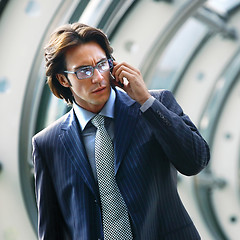 Image showing talking on mobile phone in office lobby