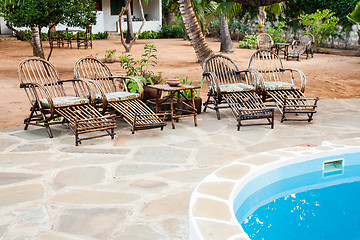 Image showing Chairs on swimming pool border