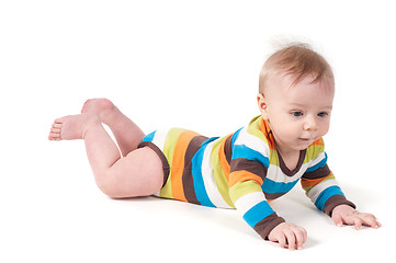 Image showing Cute kid in a striped body lying on his tummy