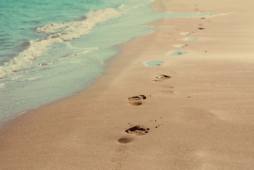 Image showing footprints on sand beach - vintage retro style