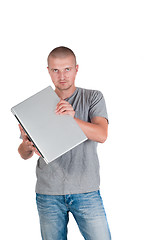 Image showing Man holding a laptop on his hands