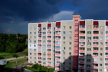 Image showing multistorey modern house and very dark rainy clouds