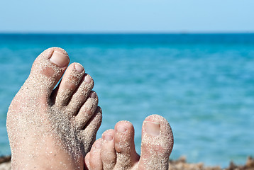 Image showing male feet on the beach