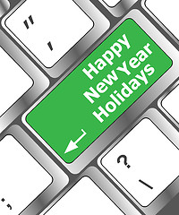 Image showing happy new year holidays button on computer keyboard key