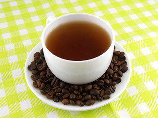 Image showing Cup of coffee with coffee beans on a beautiful yellow background