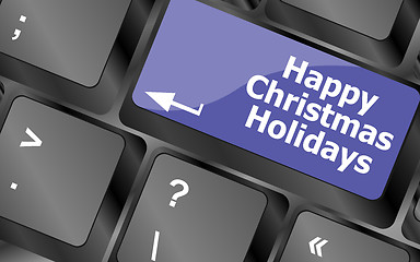 Image showing happy christmas holidays button on computer keyboard key