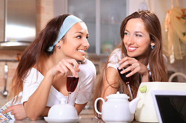 Image showing Happy women with wine in kitchen