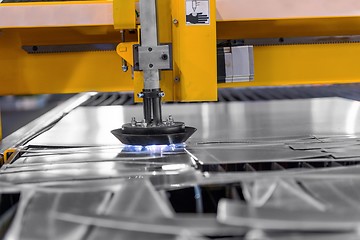 Image showing Machine cutting steel in a factory